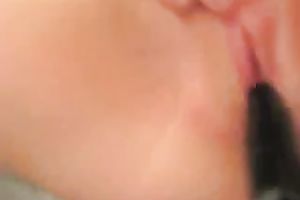 My nasty black cock sluts entertains herself by fucking her snatch with a toy