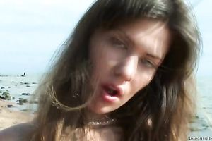 Kristina pleases herself with fervent fingering on a beach