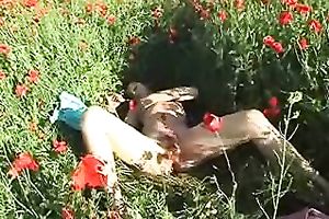 Pretty dark brown chick rubs her greatly shaggy cunt in the field