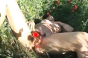 Pretty dark brown chick rubs her greatly shaggy cunt in the field