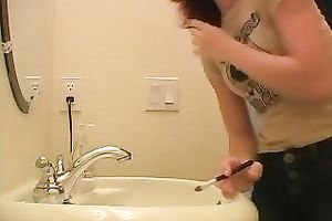 Redhead legal age teenager playgirl in the bath putting her makeup on