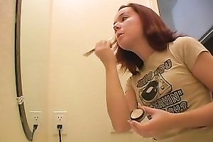 Redhead legal age teenager playgirl in the bath putting her makeup on