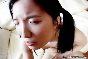 Skinny Asian cutie licks the head of a palpitating penis