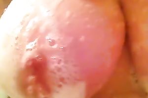 Homemade clip with my housewife playing with her large zeppelins in the shower