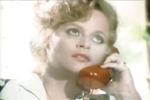 Busty blonde seductress is talking on a phone