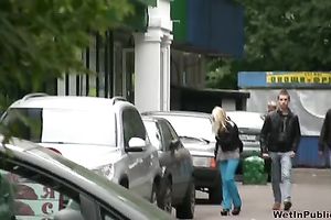 Skinny Russian golden-haired girl walks on the sidewalk and pisses
