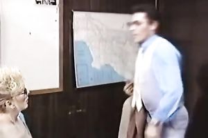 Retro blond flashes her tits and rubs a guy's rod in an office