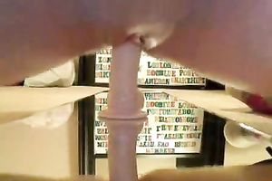 Wanton blond honey rides a suction cup marital-device on the mirror