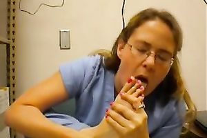 Nerdy woman in nurse uniform licks her toes in front of a livecam