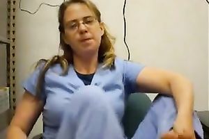 Nerdy woman in nurse uniform licks her toes in front of a livecam