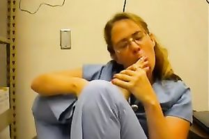 Nerdy woman in nurse uniform licks her toes in front of a livecam