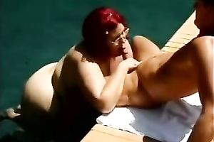 Redhead white older obese white wife by the pool is engulfing shlong