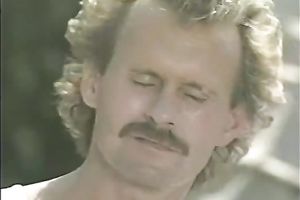 A blonde and a brunette hair go lesbo in a tent in retro porn movie