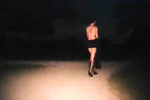 Kinky floozy strips in the midst of the street at night