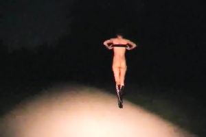 Kinky floozy strips in the midst of the street at night