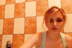 Admirable golden-haired with pierced navel looks sexy during the time that showering