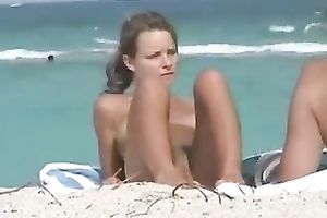 This excited playgirl on the beach is meant to be stripped