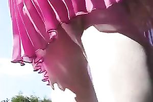 Whorish babe in pleated pink petticoat positions on camera