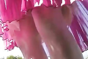 Whorish babe in pleated pink petticoat positions on camera