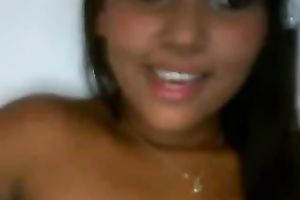 Latina babe with jet dark hair flashes her breasts and fur pie