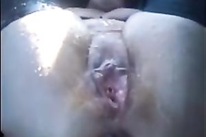 My aged short-haired slutwife plays with her shaved slit in a car