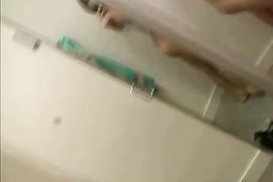 Two charming dilettante gals disrobe in front of a mirror