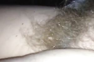 Rubbing my wife's hirsute cunt in front of a camera
