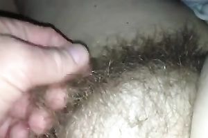 Rubbing my wife's hirsute cunt in front of a camera