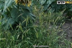 Blonde with saggy breasts fingers her twat in the field