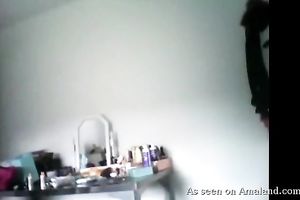 Naughty golden-haired chick disrobes on camera and exposes her bare beauty