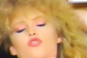 Retro blond milf entertains herself by fingering her snatch