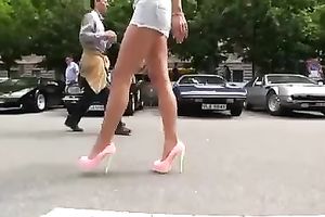 Outdoor scene with a sizzling golden-haired walking in her high heels