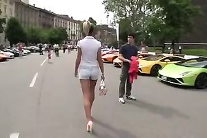 Outdoor scene with a sizzling golden-haired walking in her high heels