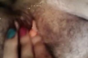 Entertaining myself by fingering my rock hard bushy slit indoors