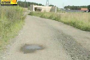 Slim housewife in lovely suit pisses on the road in the countryside