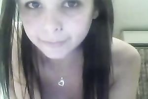 Brunette legal age teenager with big fake mounds fingers her twat in front of a web camera