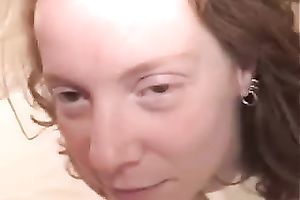 Curly haired blonde wench takes penis in her throat and receives jizzed in