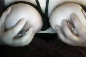 Large white milk shakes tied up with dark ropes on webcam