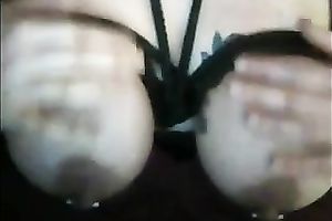 Large white milk shakes tied up with dark ropes on webcam