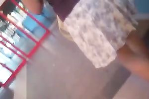 Secretly taking an upskirt movie of bootyful honey on escalator