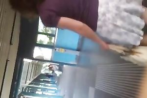 Secretly taking an upskirt movie of bootyful honey on escalator