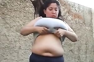 Chubby brunette milf plays with her large natural mounds outdoors
