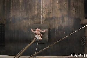 Small titted blondie fastened with ropes is tortured in barn