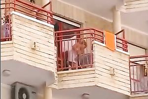 Hot small golden-haired neighbour on the balcony filmed upskirt