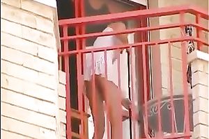 Hot small golden-haired neighbour on the balcony filmed upskirt