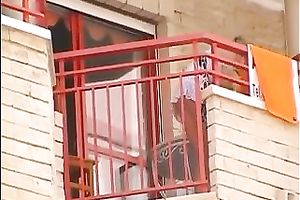 Hot small golden-haired neighbour on the balcony filmed upskirt