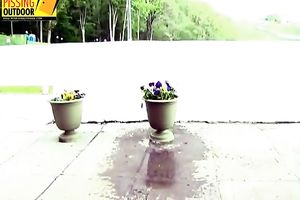 Naughty brunette hair in lengthy petticoat and nylons makes water on the flowers