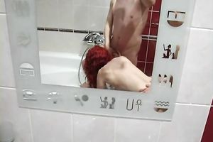 Redhead legal age teenager in the baths bows over to engulf ramrod