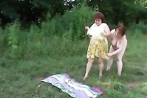 Two bulky lesbos polish every other's snatches in the nature