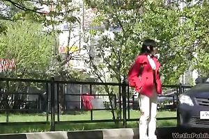 Tanya soaks her trousers in the street and changes her clothing